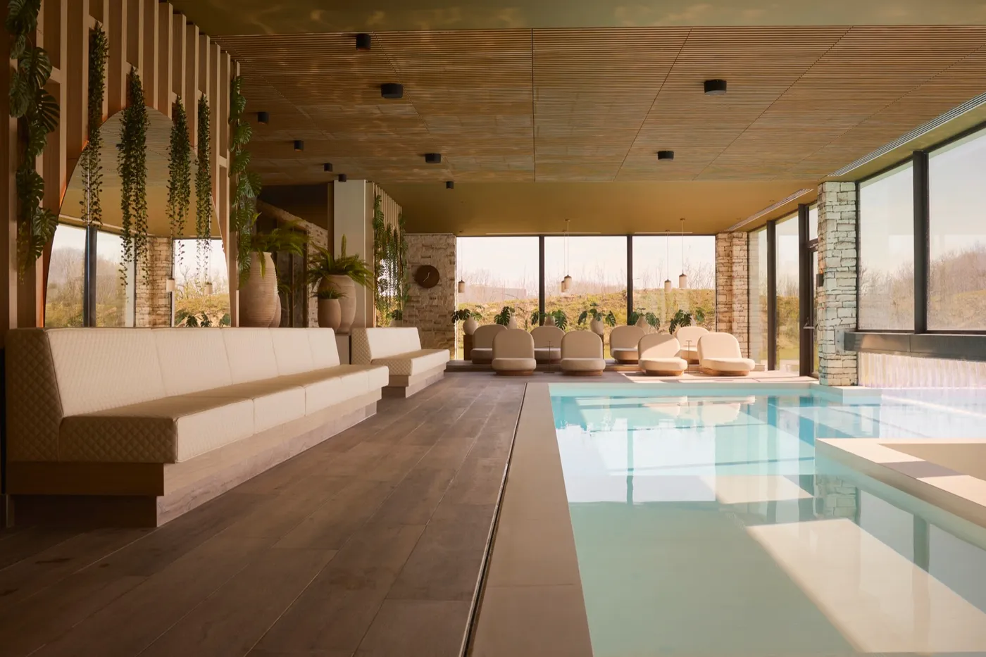 The calm indoor pool of the hotel spa, lined with soft seating