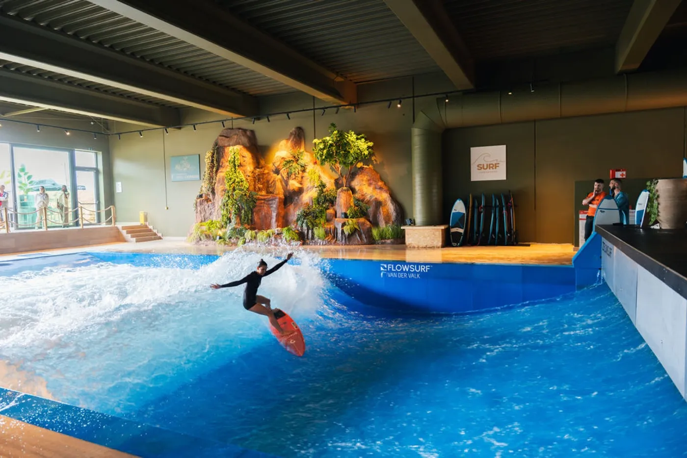 A surfer riding the standing wave in the indoor surf pool