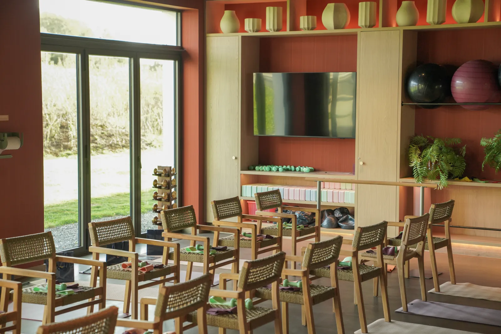 The studio set up with chairs and mats before the class