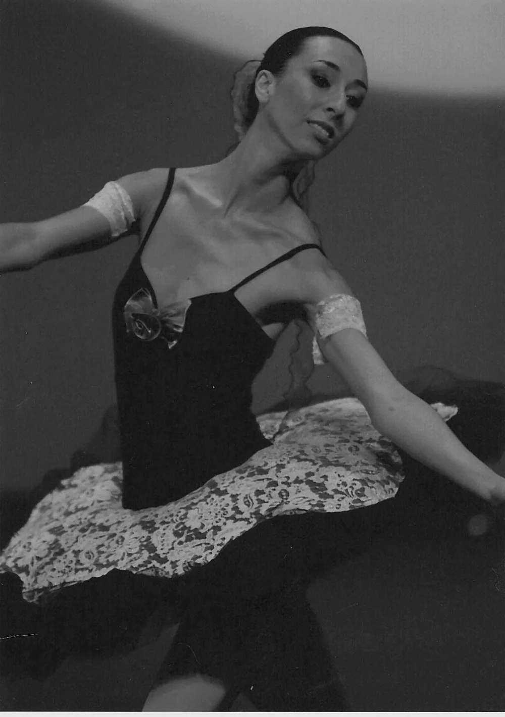 Delia performing on stage in a black tutu